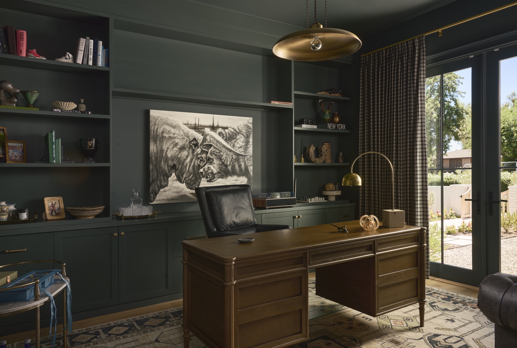 Deep green home office with custom built-in shelving