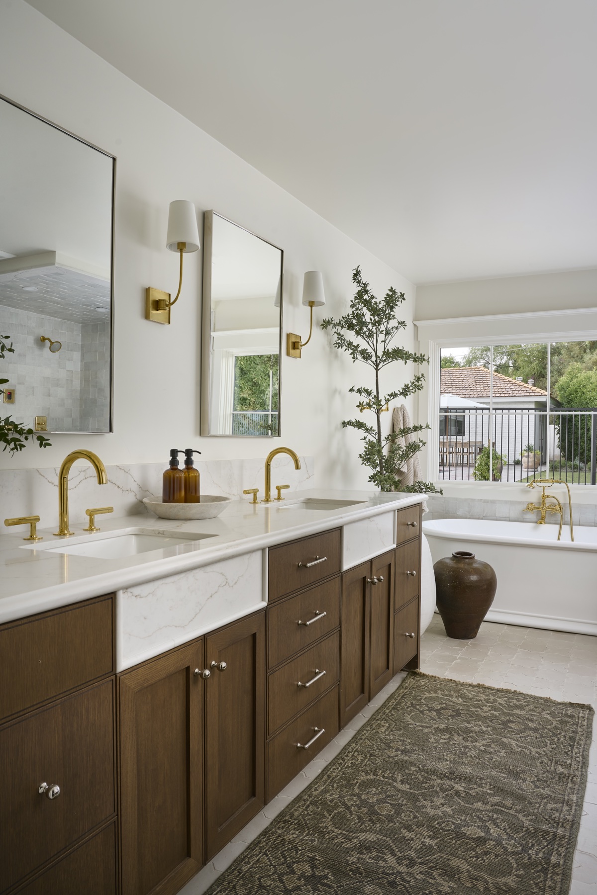 Wood vanity and bright primary bathroom at Paisano Circle